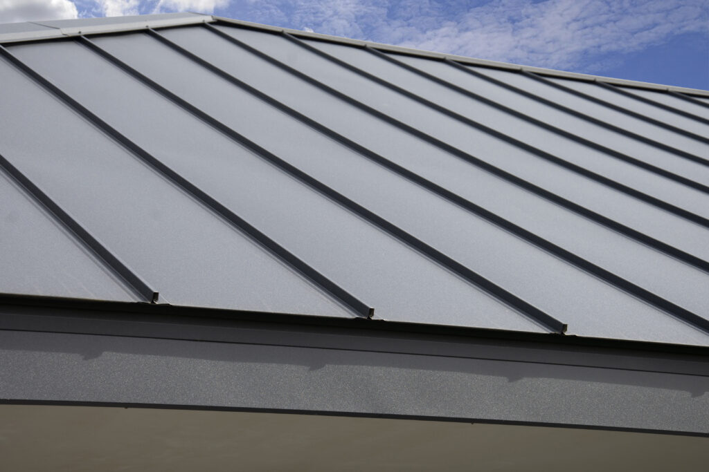 Gray Standing Seam Metal Roof on sky background